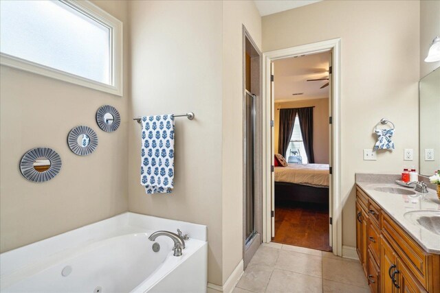 bathroom with plus walk in shower, tile patterned flooring, dual bowl vanity, and ceiling fan