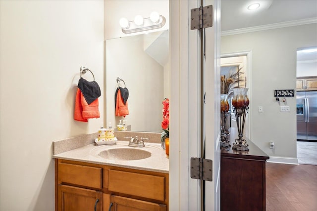 bathroom with vanity, crown molding, and wood-type flooring