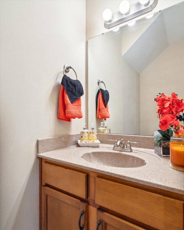 bathroom with vanity and vaulted ceiling