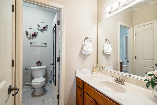 bathroom with tile patterned floors, toilet, and vanity