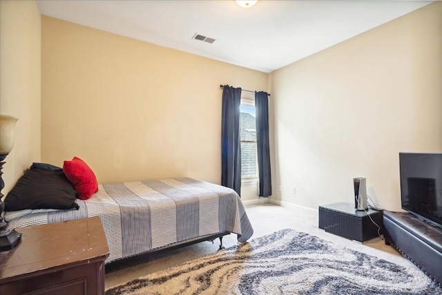 bedroom with carpet, visible vents, and baseboards