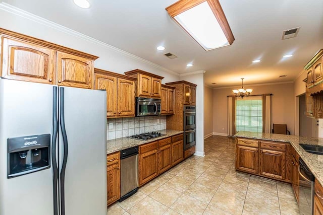 kitchen featuring light stone counters, crown molding, an inviting chandelier, appliances with stainless steel finishes, and decorative backsplash