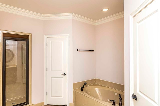 bathroom featuring crown molding and separate shower and tub