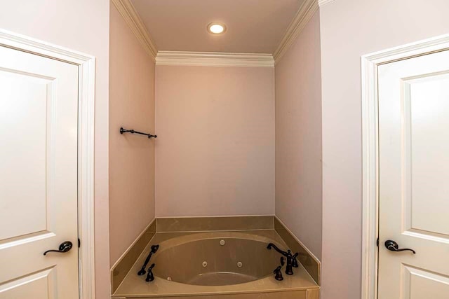 bathroom featuring ornamental molding and a bath