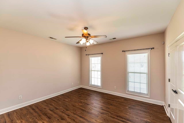 unfurnished room featuring ceiling fan and dark hardwood / wood-style flooring