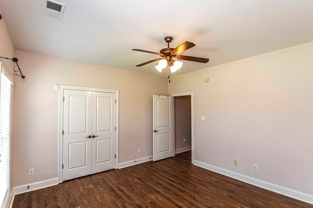 unfurnished bedroom with ceiling fan and dark hardwood / wood-style flooring