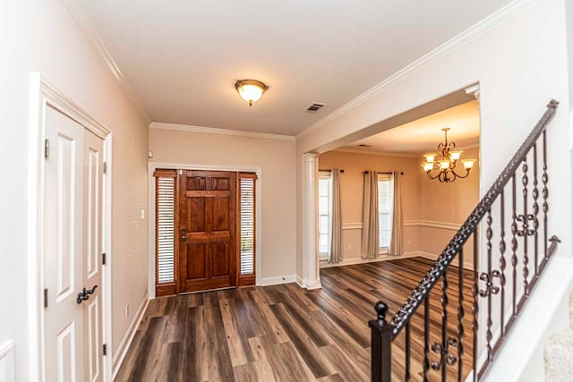 foyer featuring crown molding, an inviting chandelier, and dark hardwood / wood-style flooring