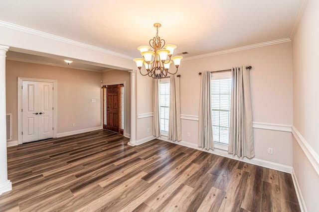 unfurnished room featuring an inviting chandelier, crown molding, and dark wood-type flooring