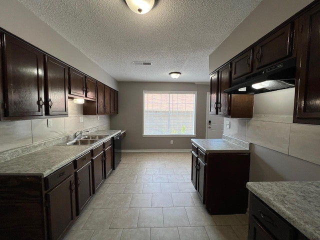 kitchen featuring black dishwasher, decorative backsplash, a sink, dark brown cabinets, and under cabinet range hood