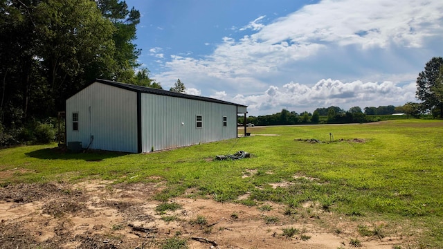 view of yard featuring a rural view and an outbuilding