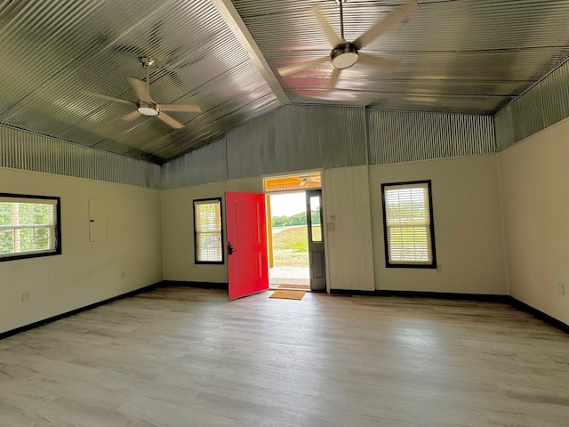 spare room featuring vaulted ceiling, hardwood / wood-style floors, and ceiling fan