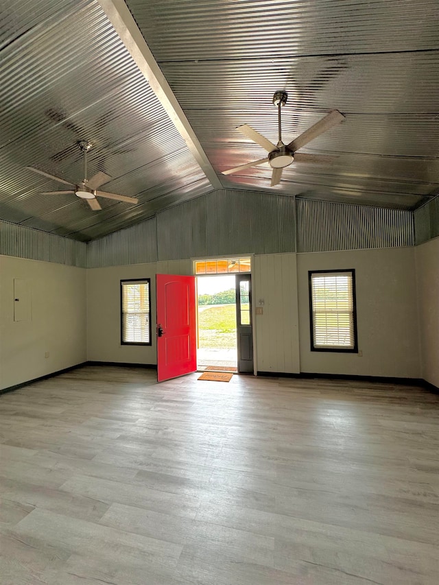 unfurnished room with hardwood / wood-style floors, ceiling fan, and vaulted ceiling