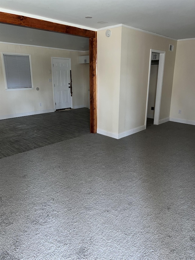 carpeted spare room with visible vents, crown molding, and baseboards