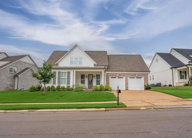 view of front of house featuring a garage, a front lawn, and covered porch