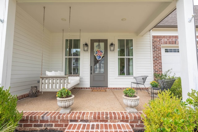 property entrance featuring a garage and covered porch