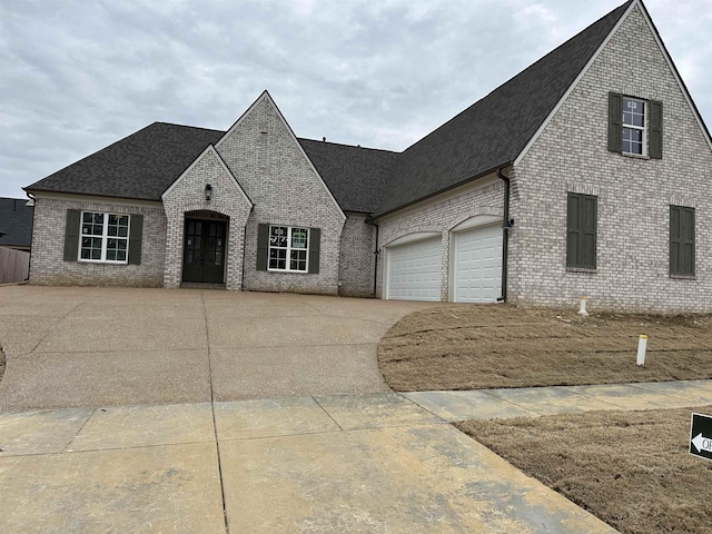 french provincial home with a garage