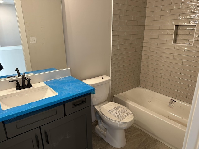 full bathroom with tiled shower / bath, vanity, and toilet