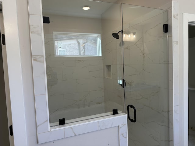 bathroom with a shower with door