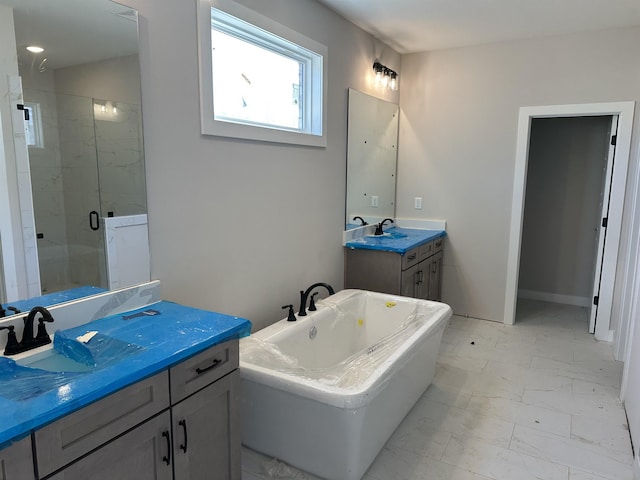 bathroom with independent shower and bath and vanity