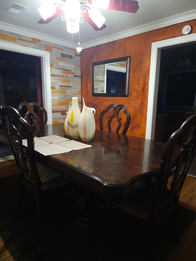 dining area with crown molding, wood-type flooring, and ceiling fan