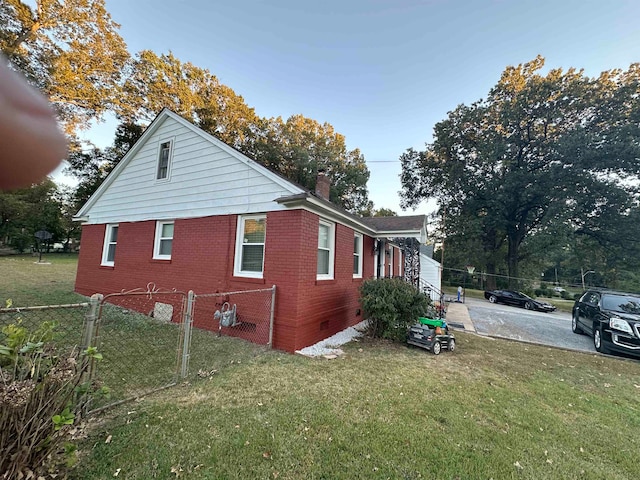 view of property exterior with a yard