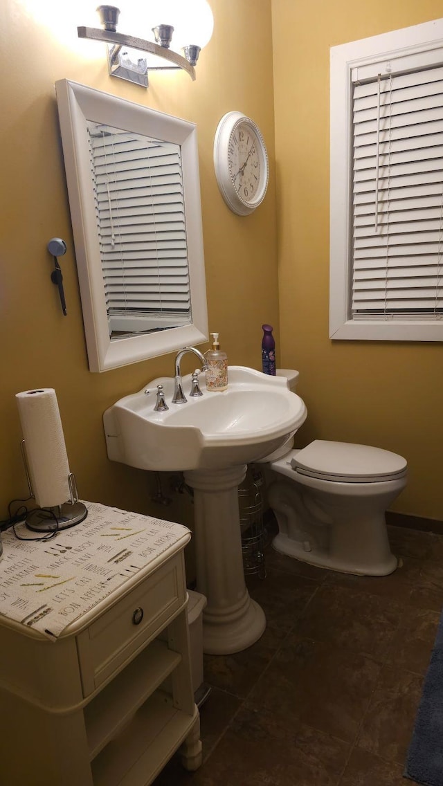 bathroom with toilet and tile patterned flooring