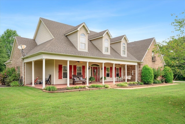 cape cod home with a front lawn and covered porch