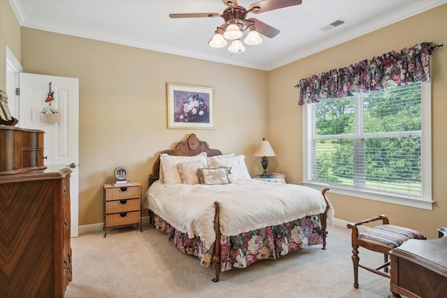 bedroom with ornamental molding, light carpet, and ceiling fan