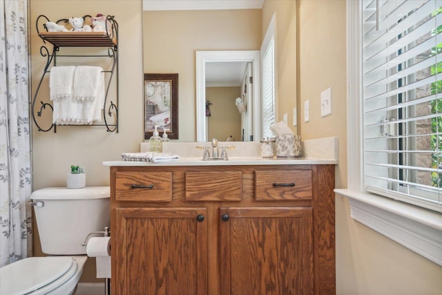 bathroom with vanity, a healthy amount of sunlight, and toilet