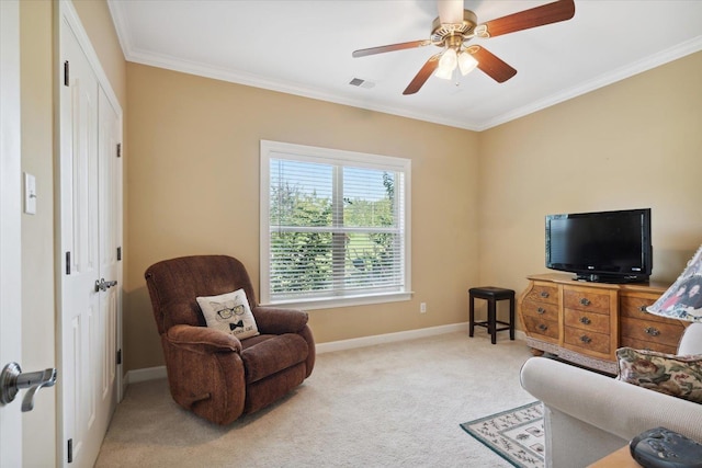 sitting room with crown molding, ceiling fan, and carpet