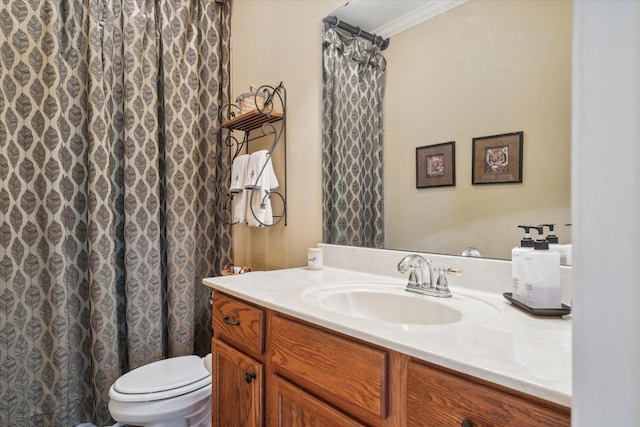 bathroom with crown molding, vanity, and toilet