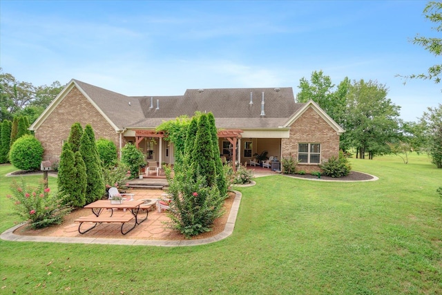 back of property with a pergola, a lawn, and a patio