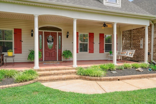 entrance to property featuring ceiling fan and a porch