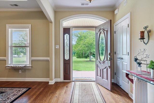 entrance foyer featuring hardwood / wood-style floors and crown molding