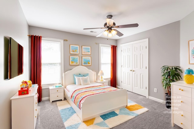 carpeted bedroom featuring ceiling fan and a closet