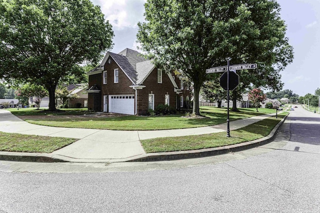 view of front of property featuring a garage and a front lawn