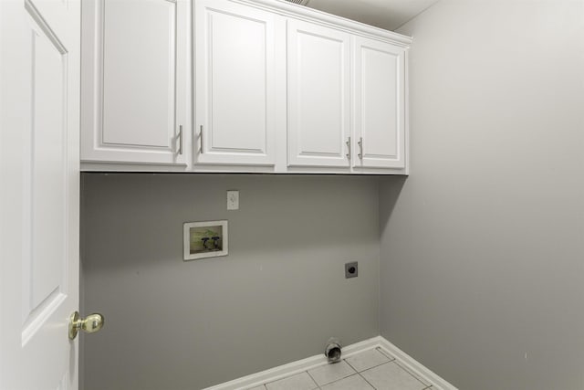 washroom featuring electric dryer hookup, hookup for a washing machine, cabinets, and light tile patterned flooring