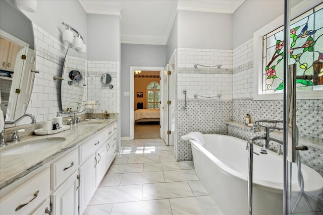 full bathroom with a freestanding tub, a wealth of natural light, double vanity, ensuite bath, and crown molding