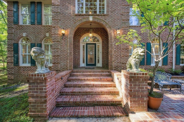 doorway to property featuring brick siding