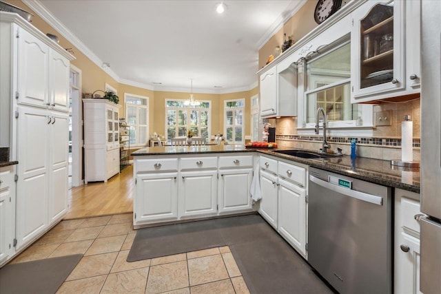 kitchen featuring white cabinetry, dishwasher, a peninsula, and a sink