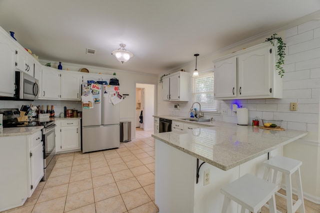 kitchen featuring white cabinets, kitchen peninsula, backsplash, and stainless steel appliances