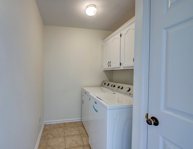 clothes washing area with cabinets, light tile patterned flooring, and separate washer and dryer