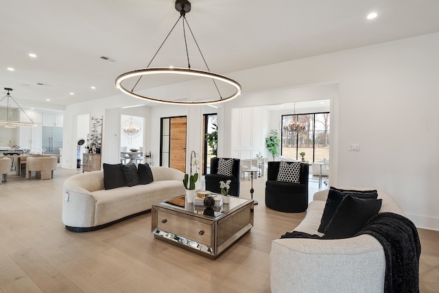 living room featuring light hardwood / wood-style floors and a chandelier