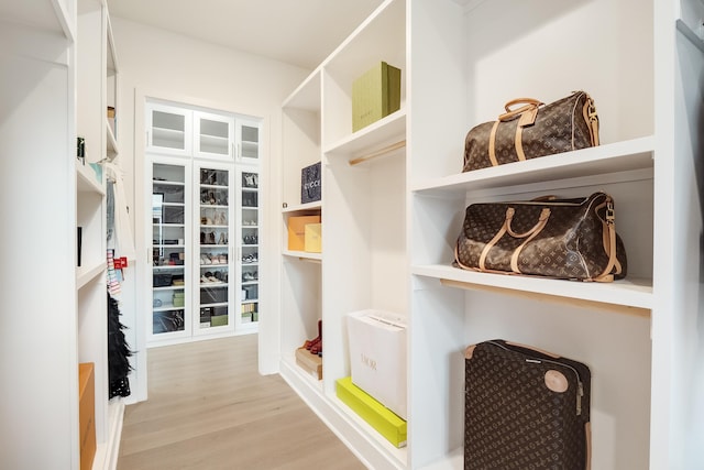 spacious closet featuring light hardwood / wood-style flooring