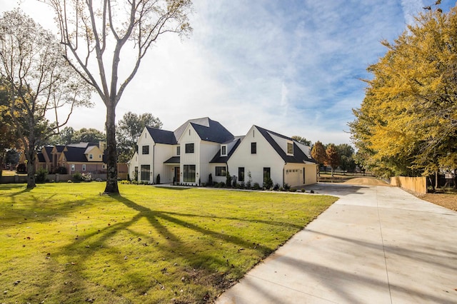 view of front of property with a garage and a front lawn