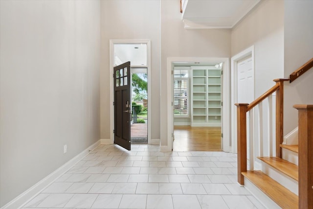 tiled entrance foyer featuring ornamental molding