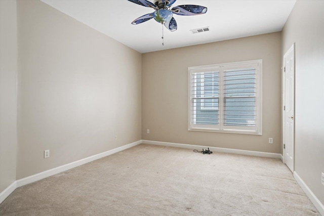 carpeted spare room featuring ceiling fan