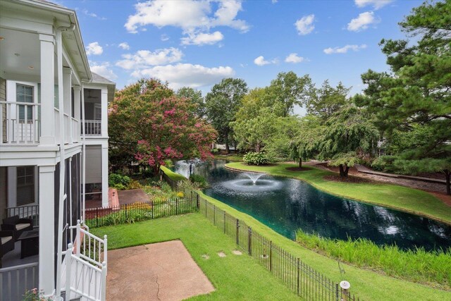 view of community featuring a water view and a lawn