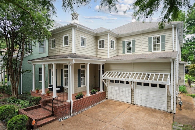 view of front of home featuring a porch and a garage