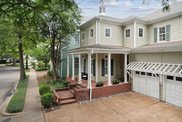 view of front of property with a garage and covered porch